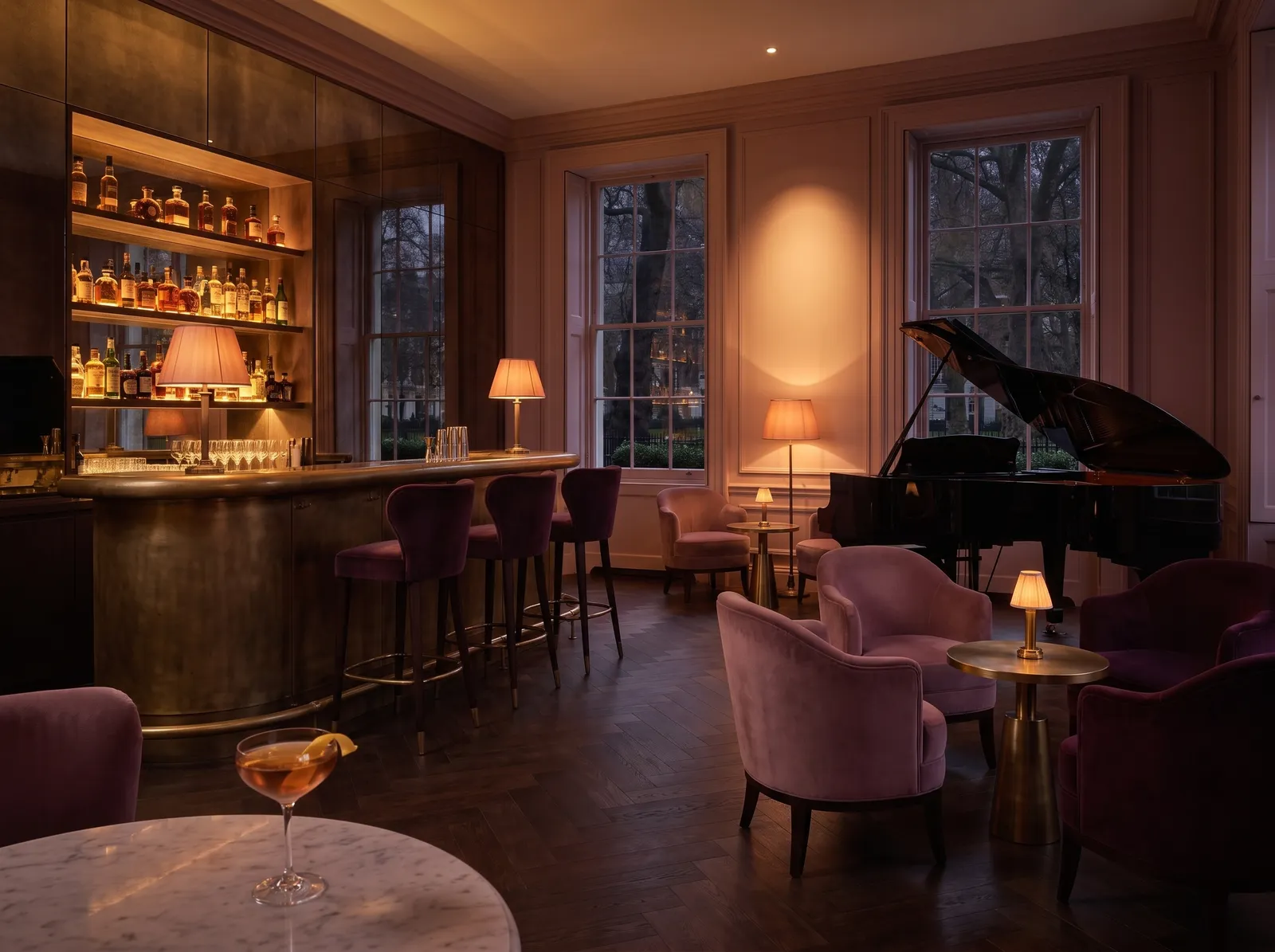 Nocturne: a curved brass bar, velvet stools and a grand piano under a warm spotlight